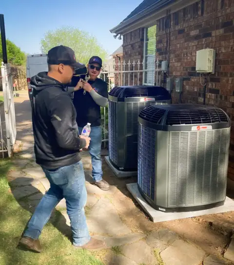 HPH Services crew installing a residential Trane AC unit.