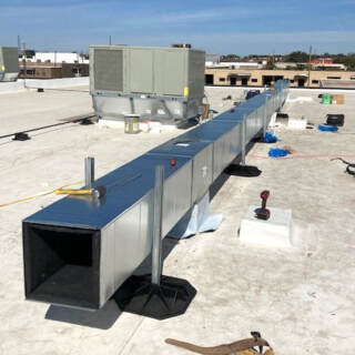 HPH Services professional installation of rooftoop commercial air conditioning unit.